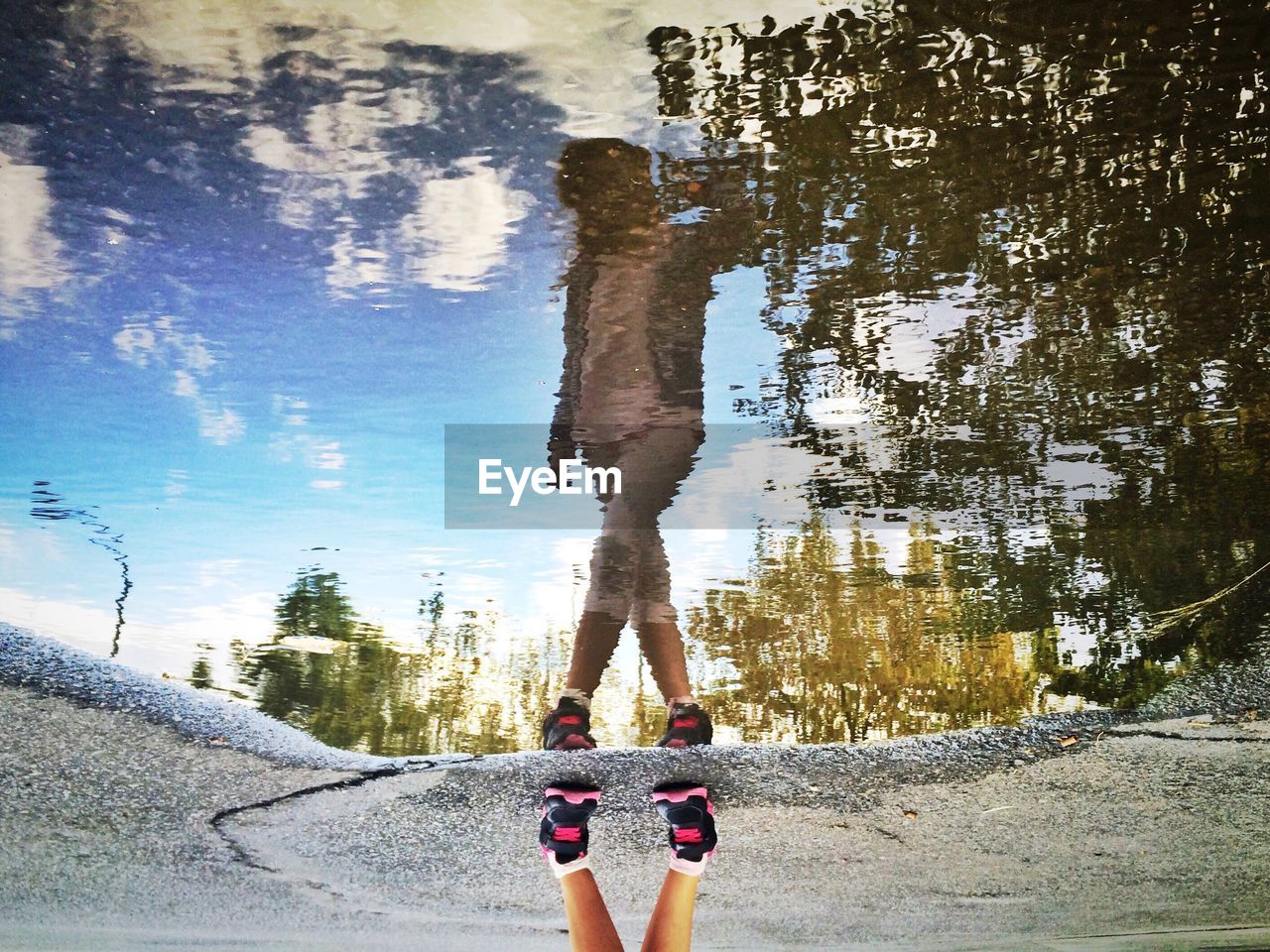 High angle view of woman reflecting in puddle