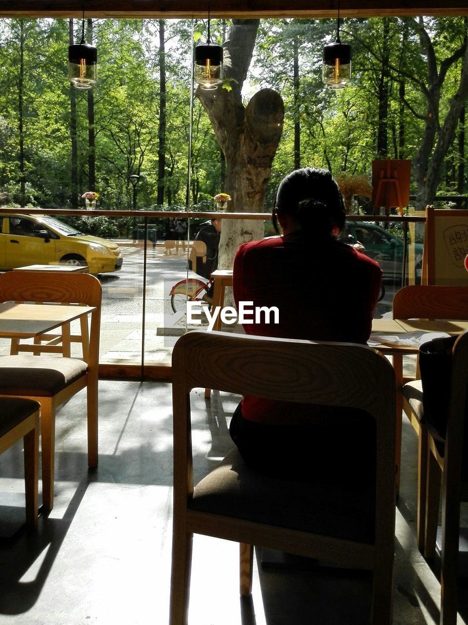 Rear view of woman sitting in cafe