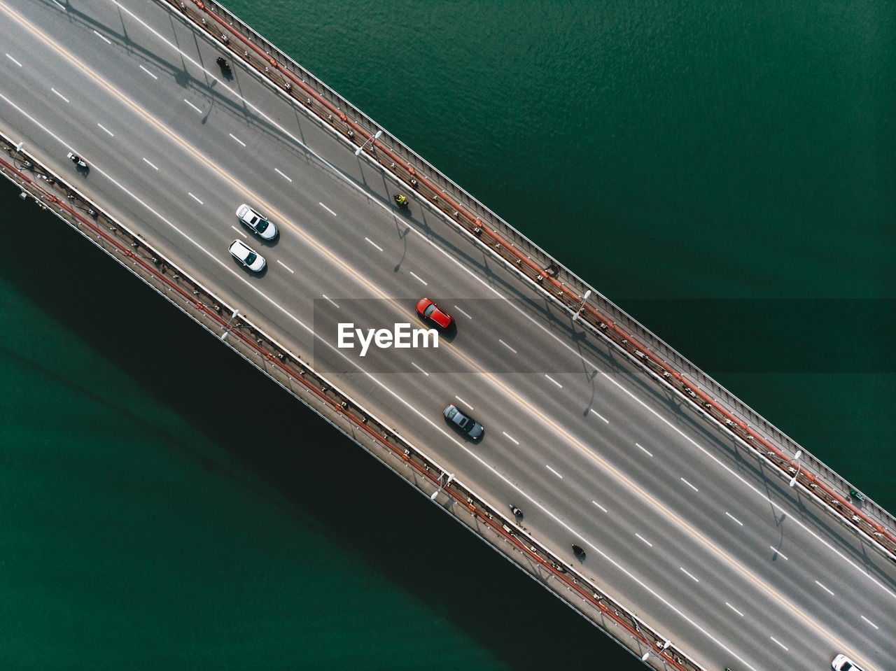 Aerial view of cars moving on bridge over sea