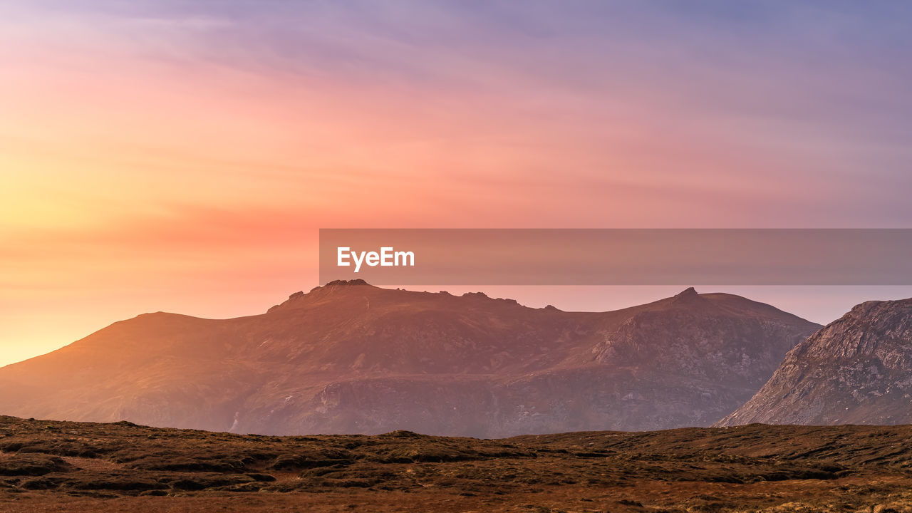 SCENIC VIEW OF MOUNTAINS AGAINST SKY DURING SUNSET