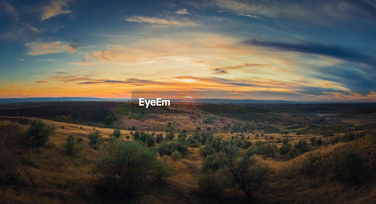 Scenic view of landscape against sky during sunset