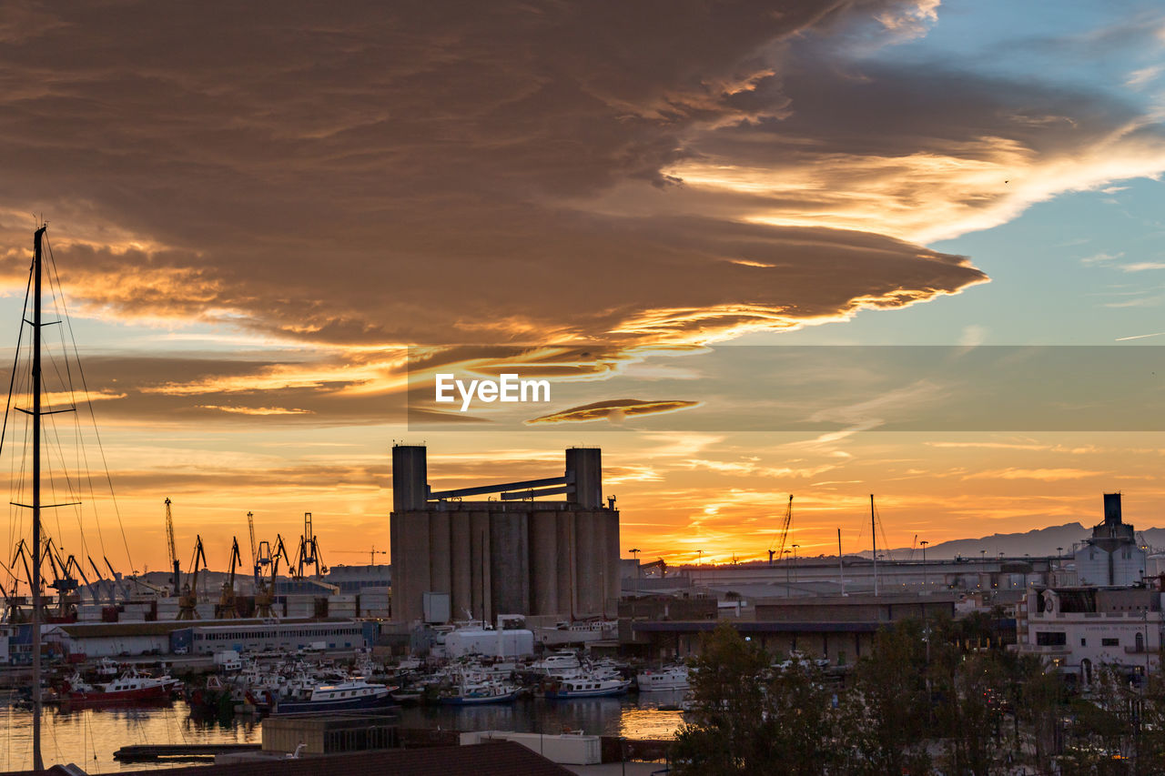 Buildings in city during sunset