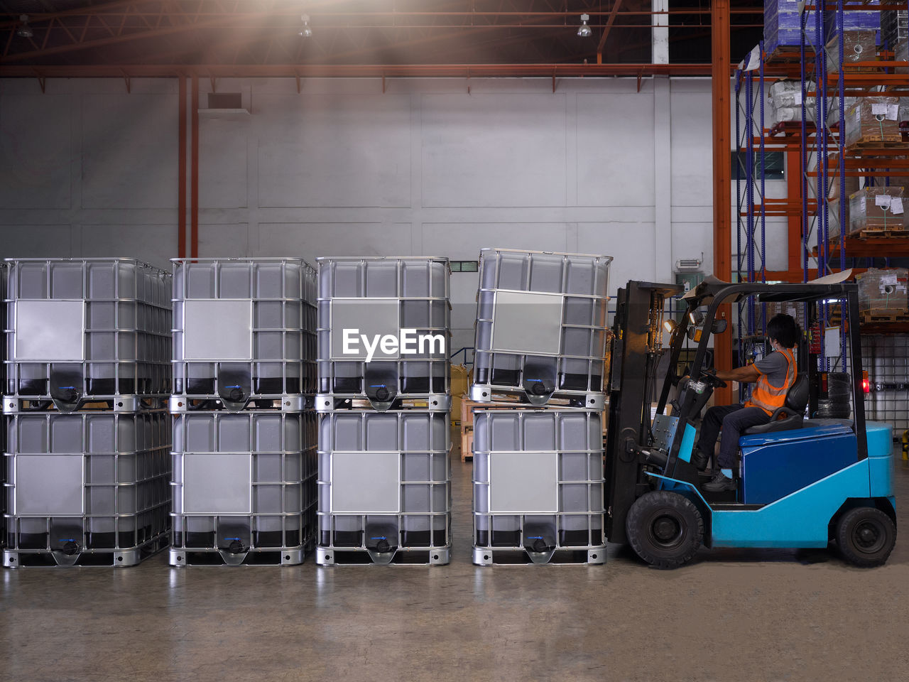 Close-up of forklift by containers