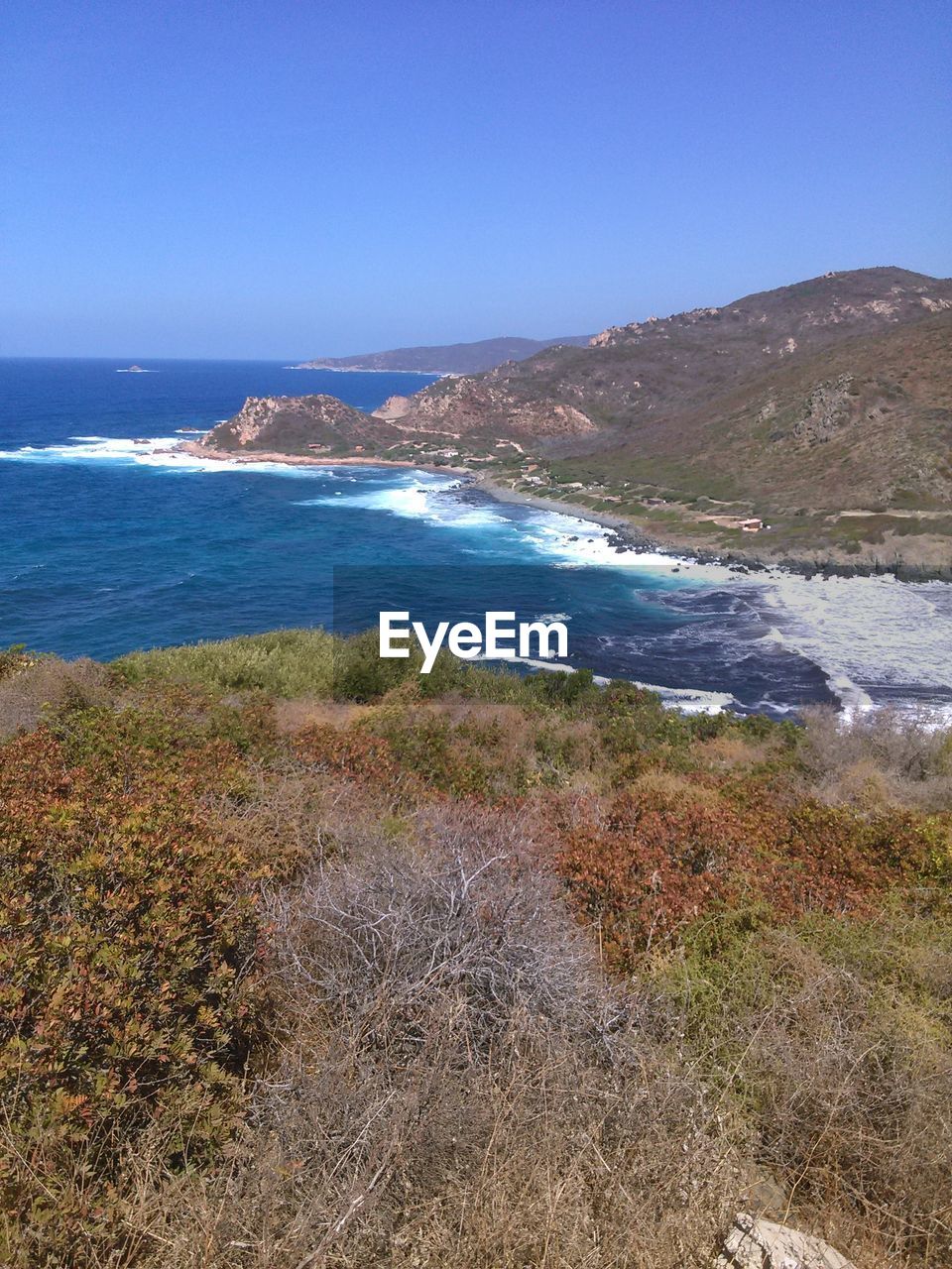 Scenic view of beach and sea against clear sky