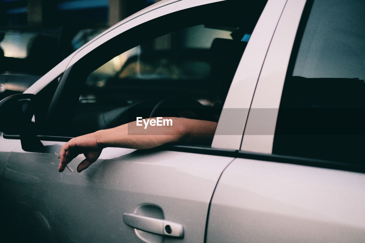 CLOSE-UP OF PERSON HAND IN CAR