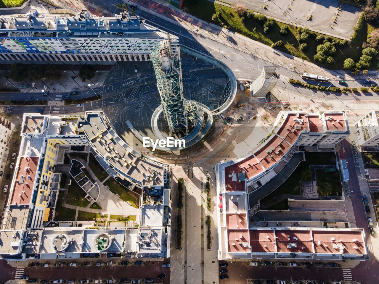 HIGH ANGLE VIEW OF CONSTRUCTION SITE WITH BUILDINGS IN BACKGROUND