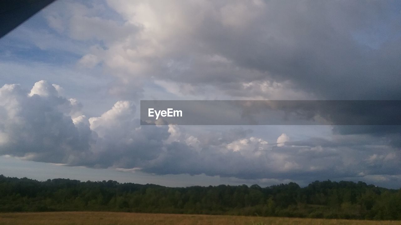 VIEW OF FIELD AGAINST CLOUDY SKY