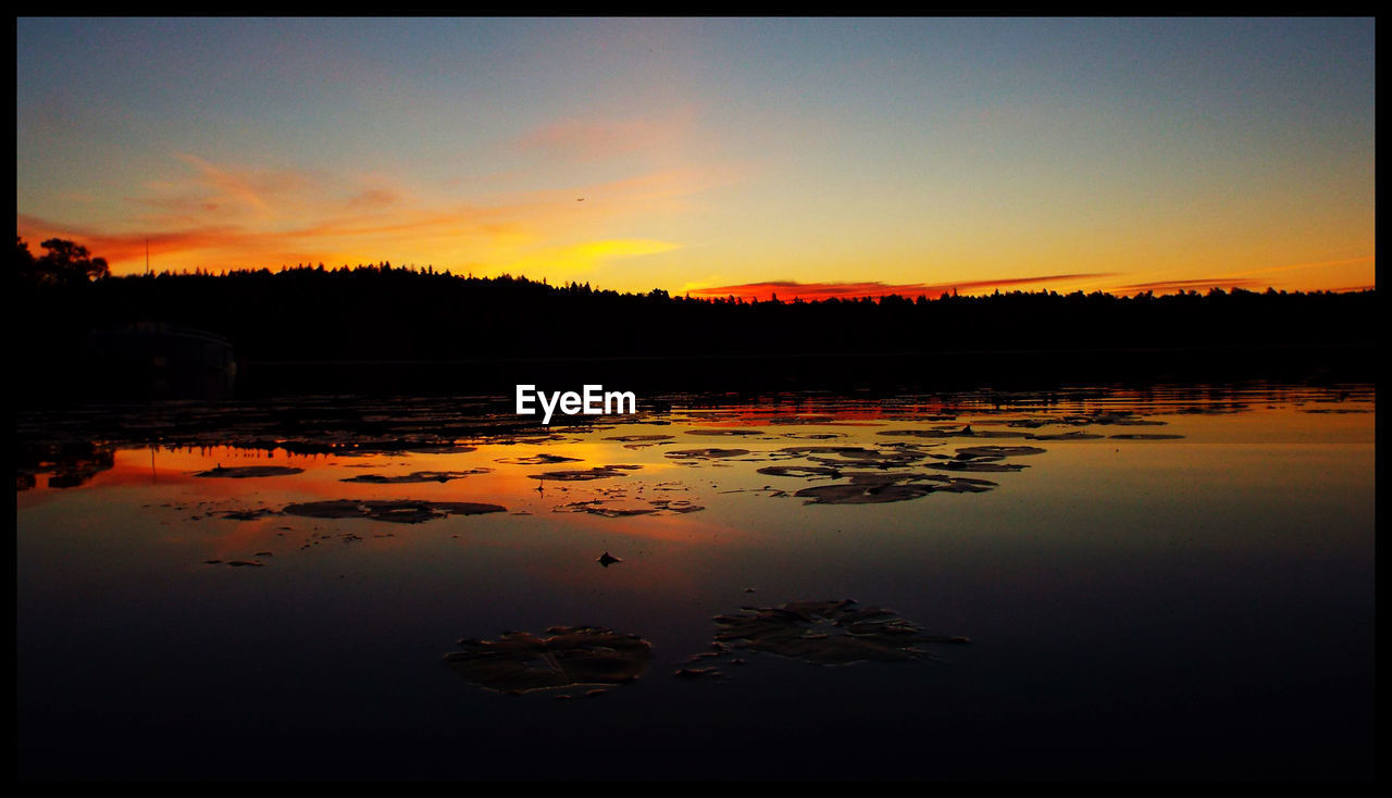 Scenic view of lake during sunset