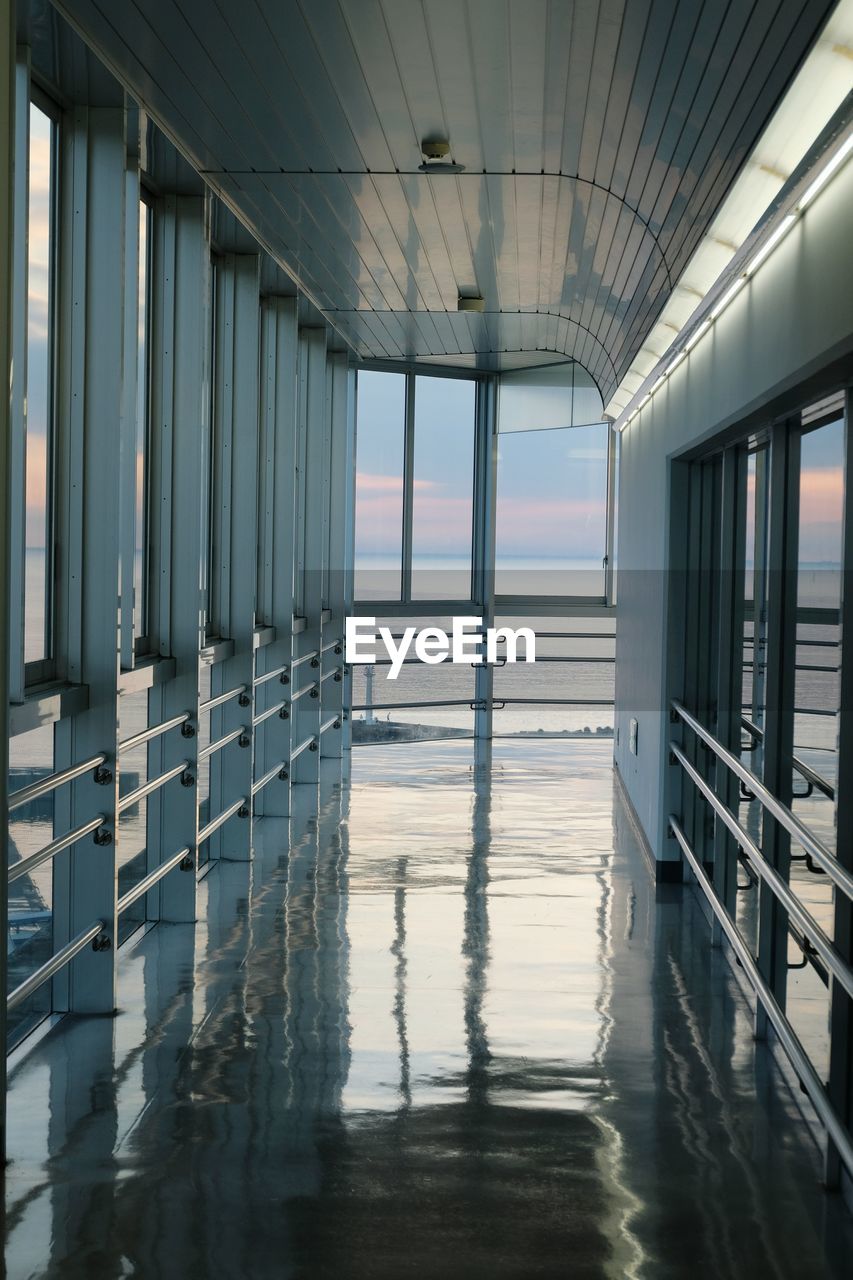 Building and seascape reflected on the floor