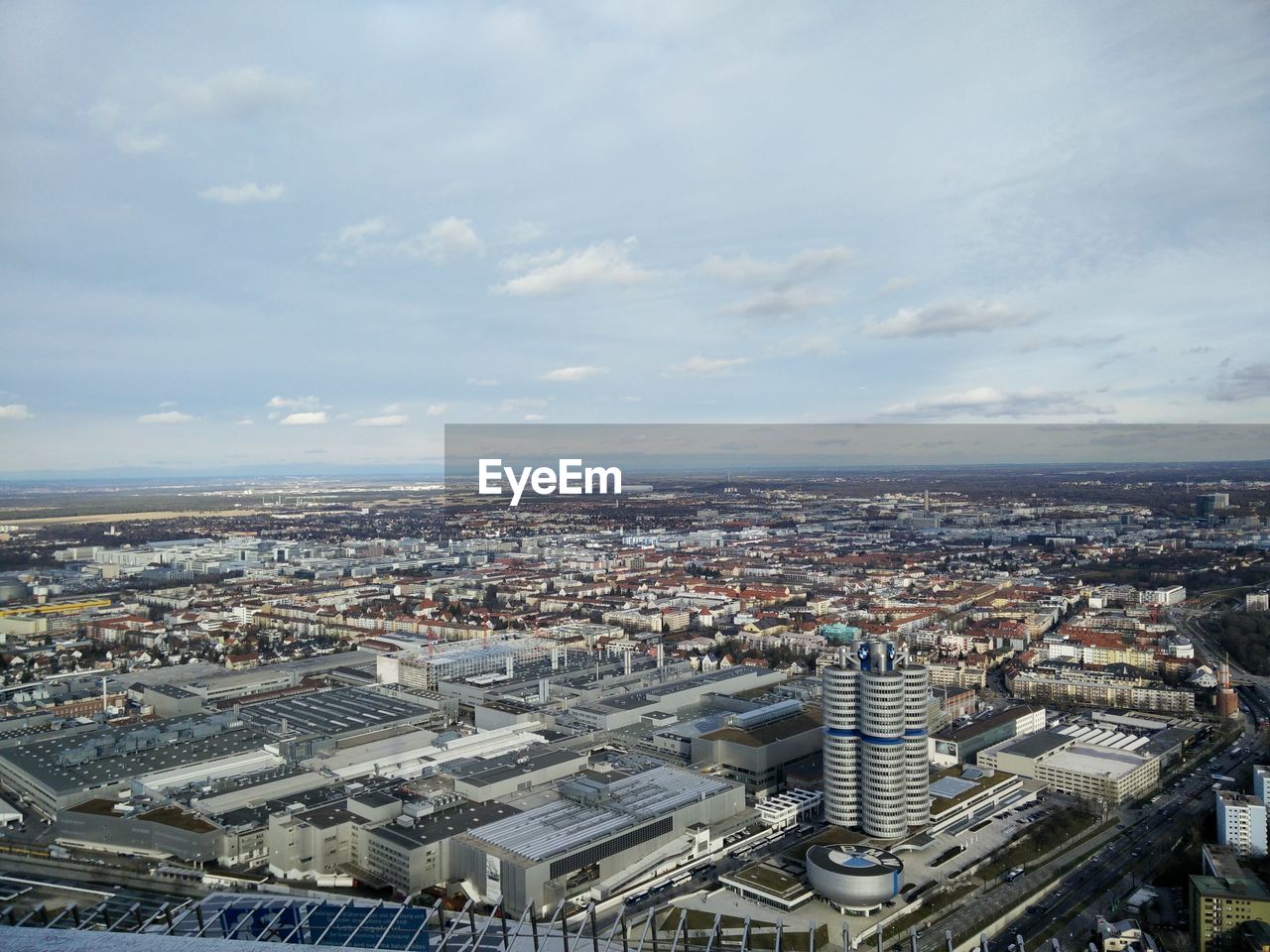 High angle view of cityscape against cloudy sky