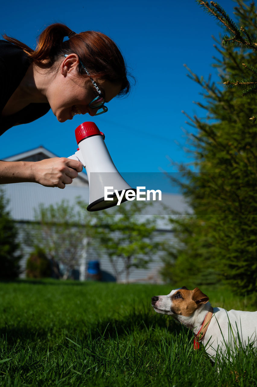 Woman with dog on field