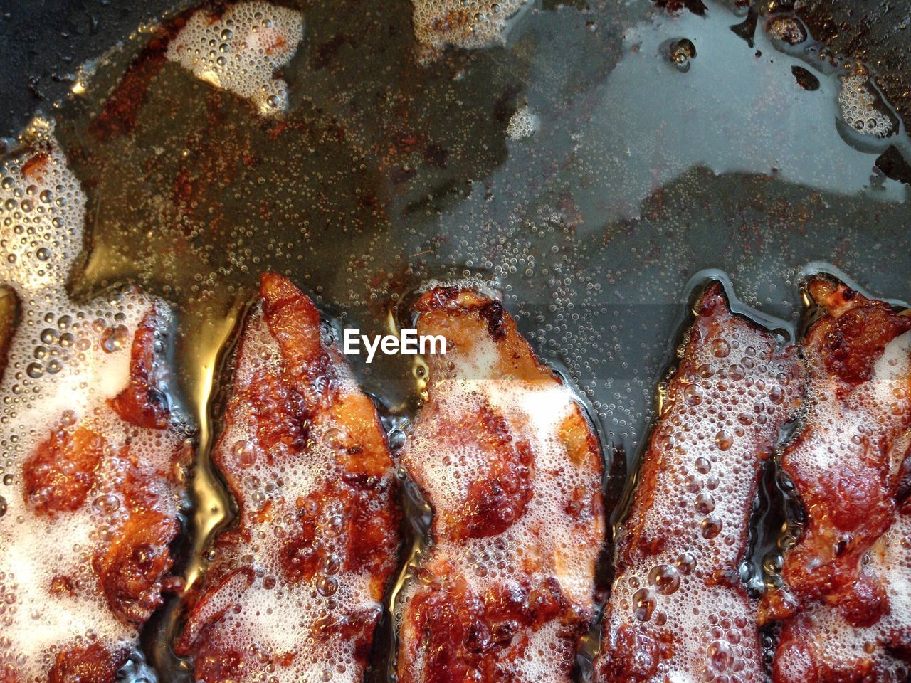 High angle view of bacons in cooking pan