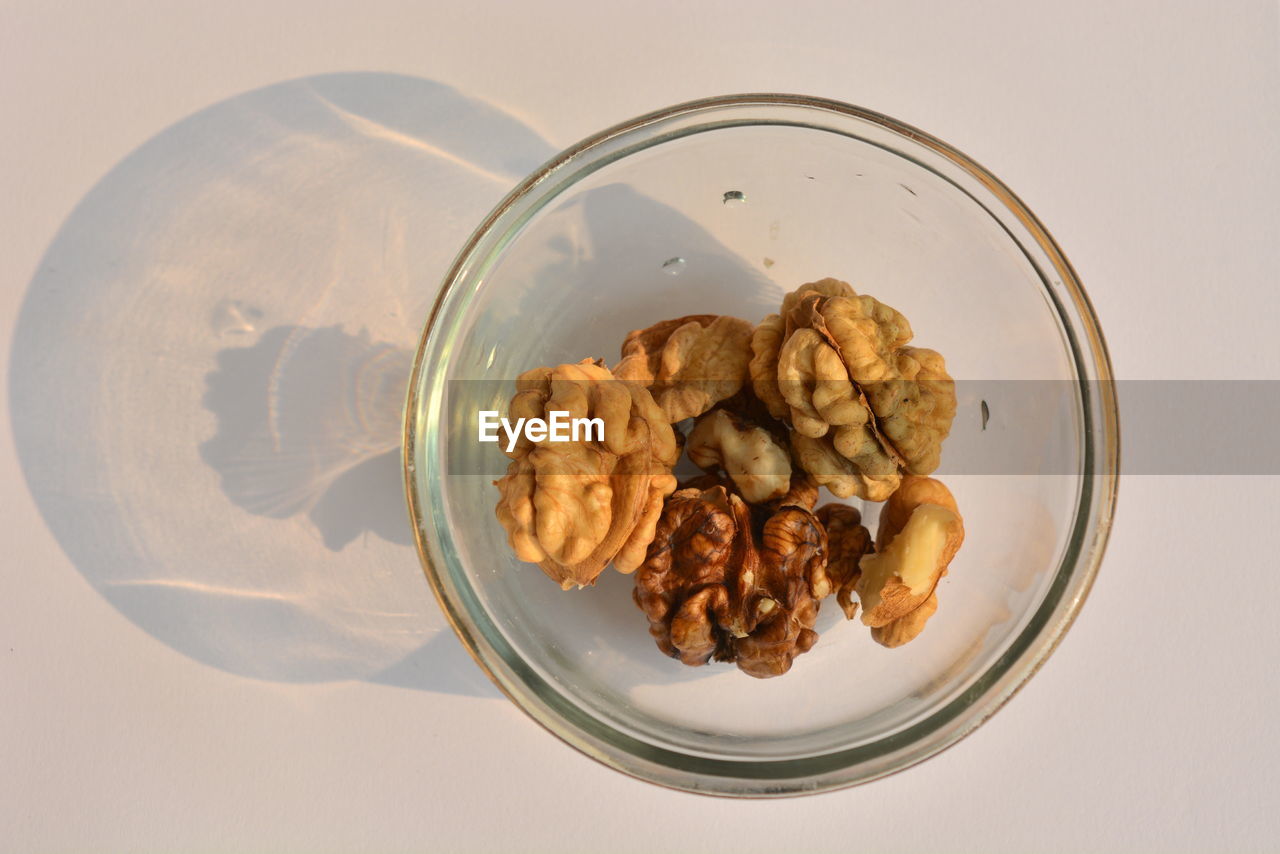 Directly above shot of walnuts in glass bowl on table