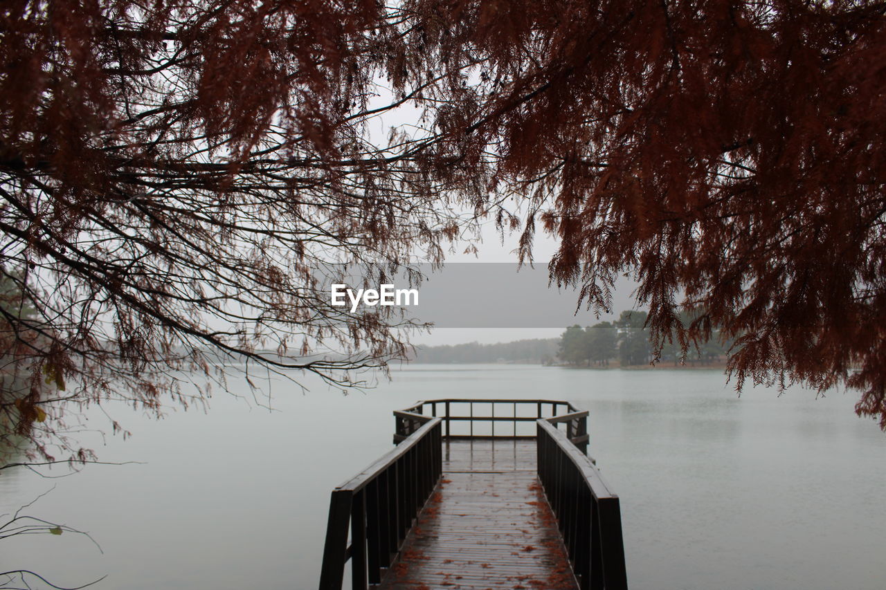 Pier over lake against sky