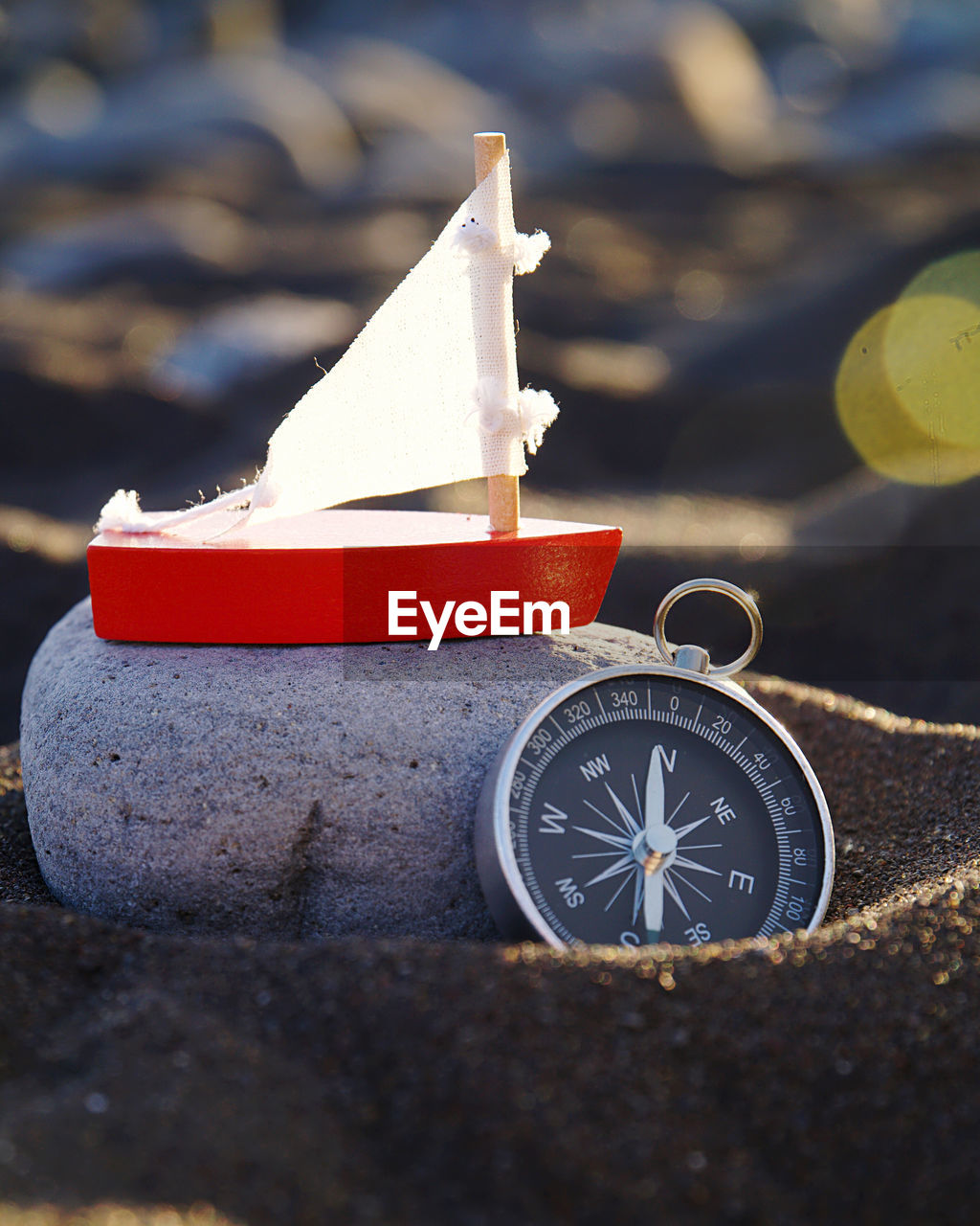 Stilllife on beach with navigational compass 