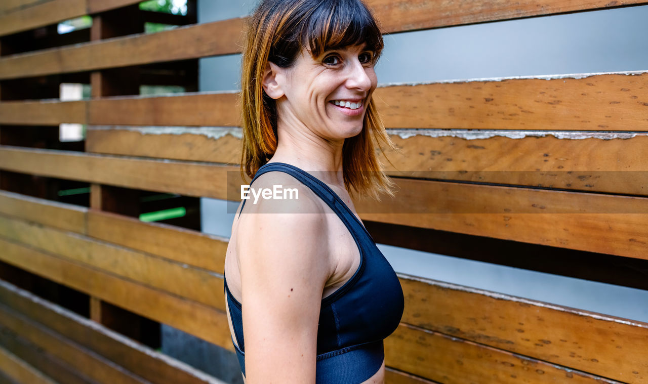 Portrait of smiling woman standing outdoors