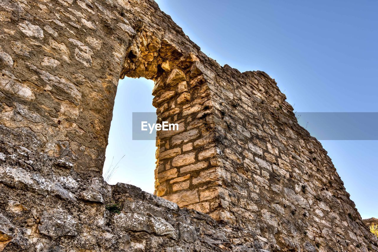 Low angle view of old ruins against sky