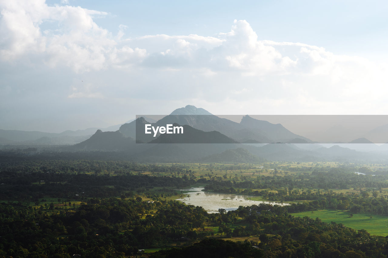 Scenic view of lake and mountains against sky