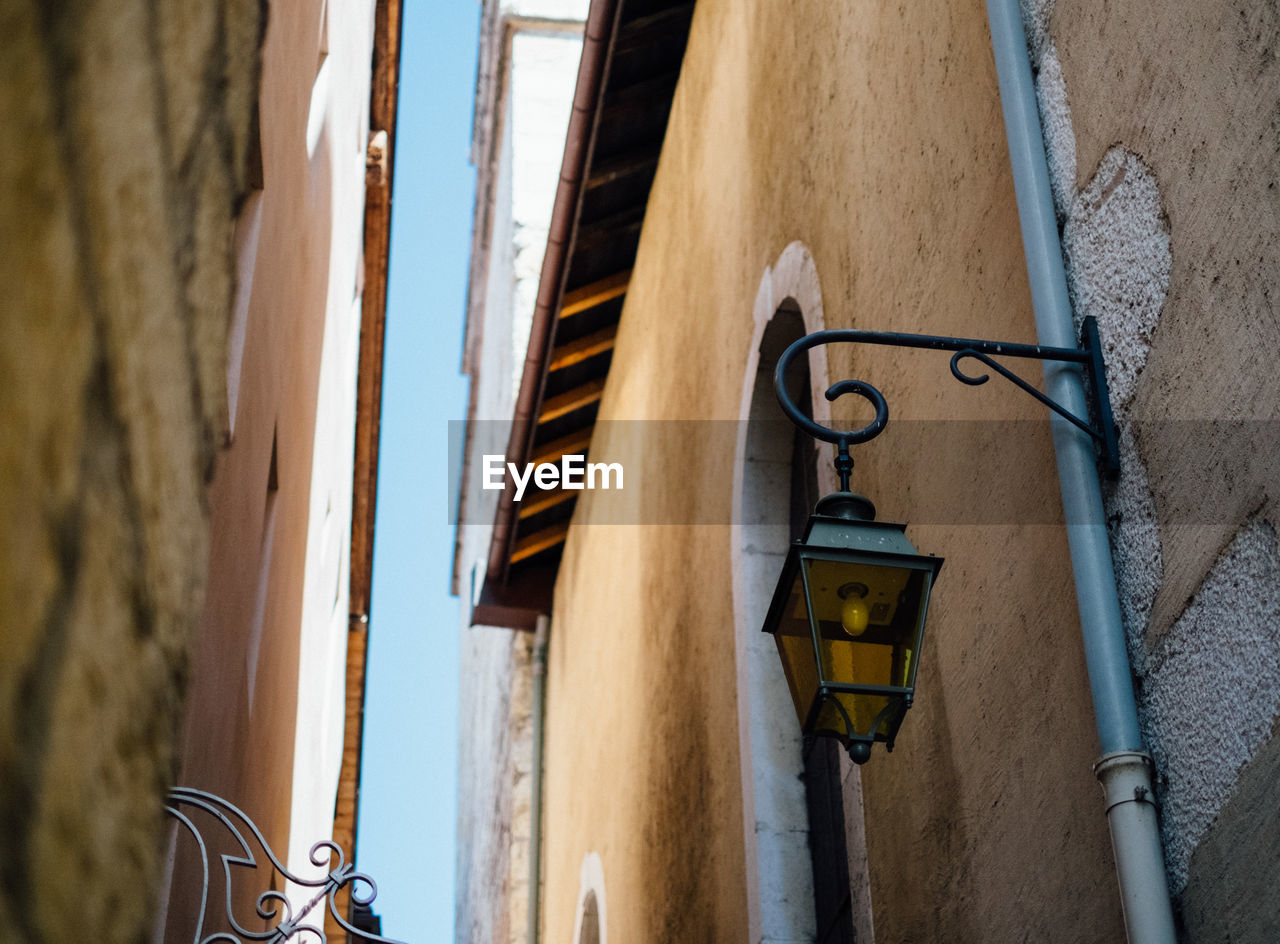 Low angle view of street light on wall