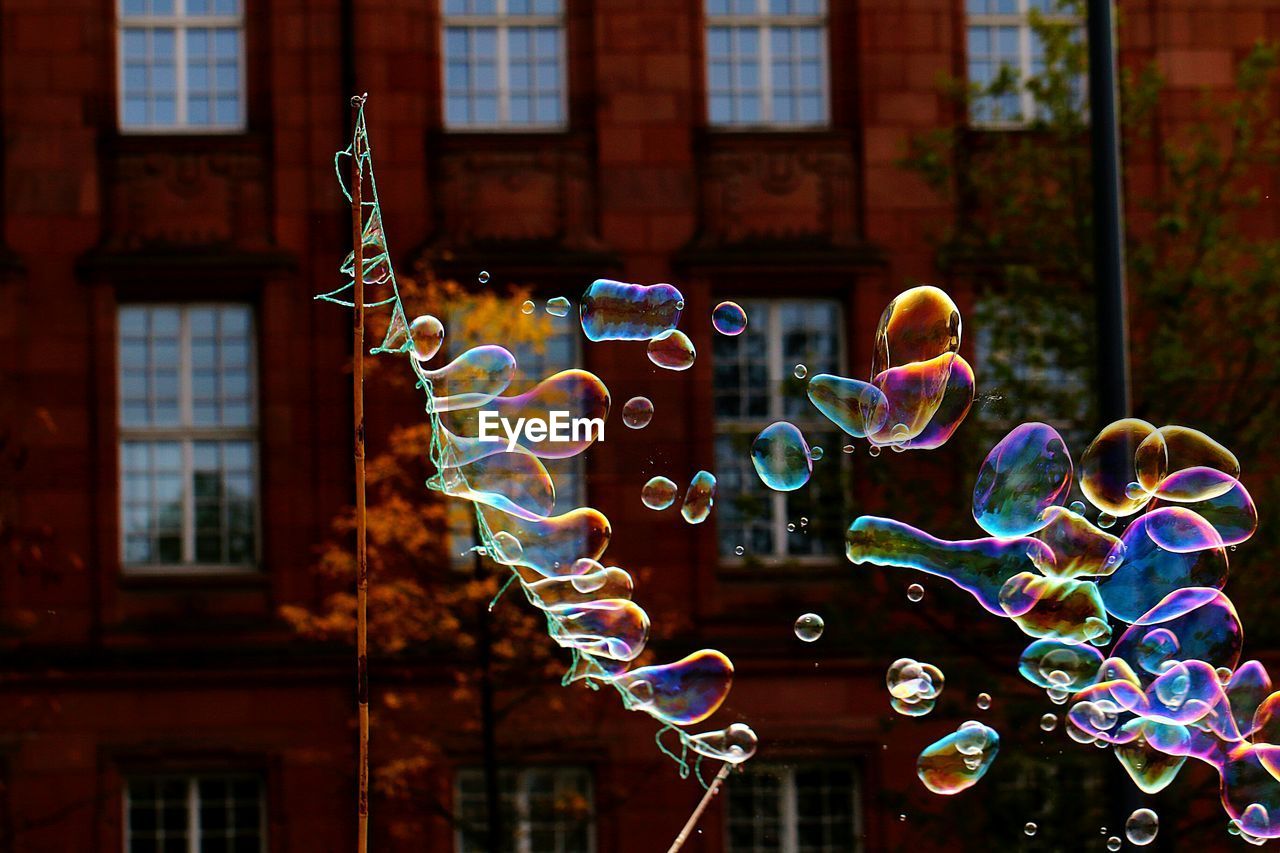 Close-up of bubbles against rainbow in building