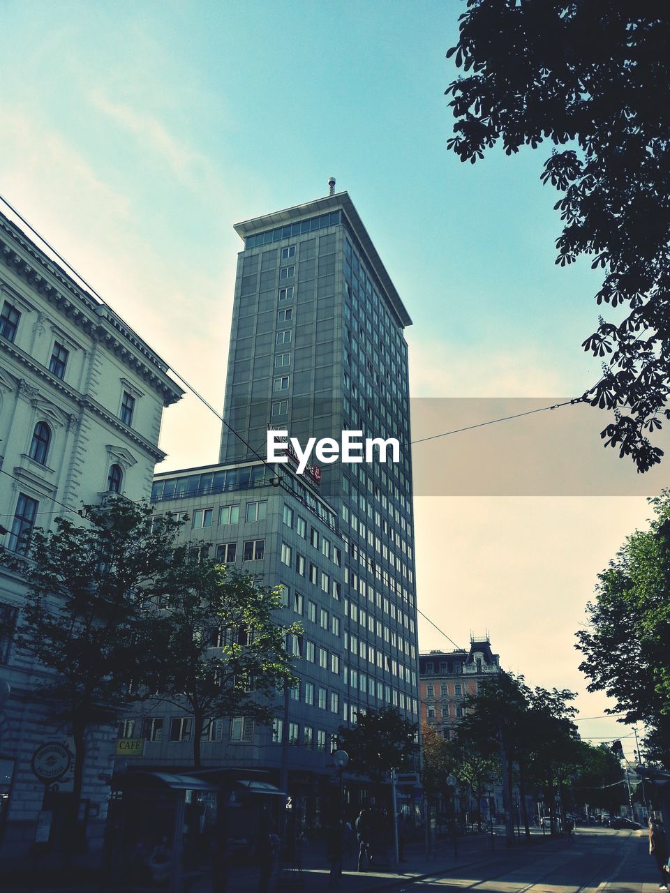 Street by buildings against sky