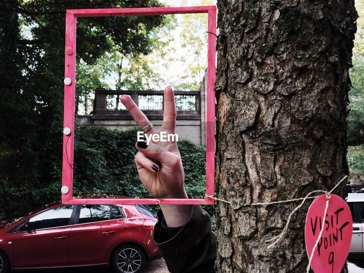 CROPPED IMAGE OF WOMAN LOOKING THROUGH WINDOW