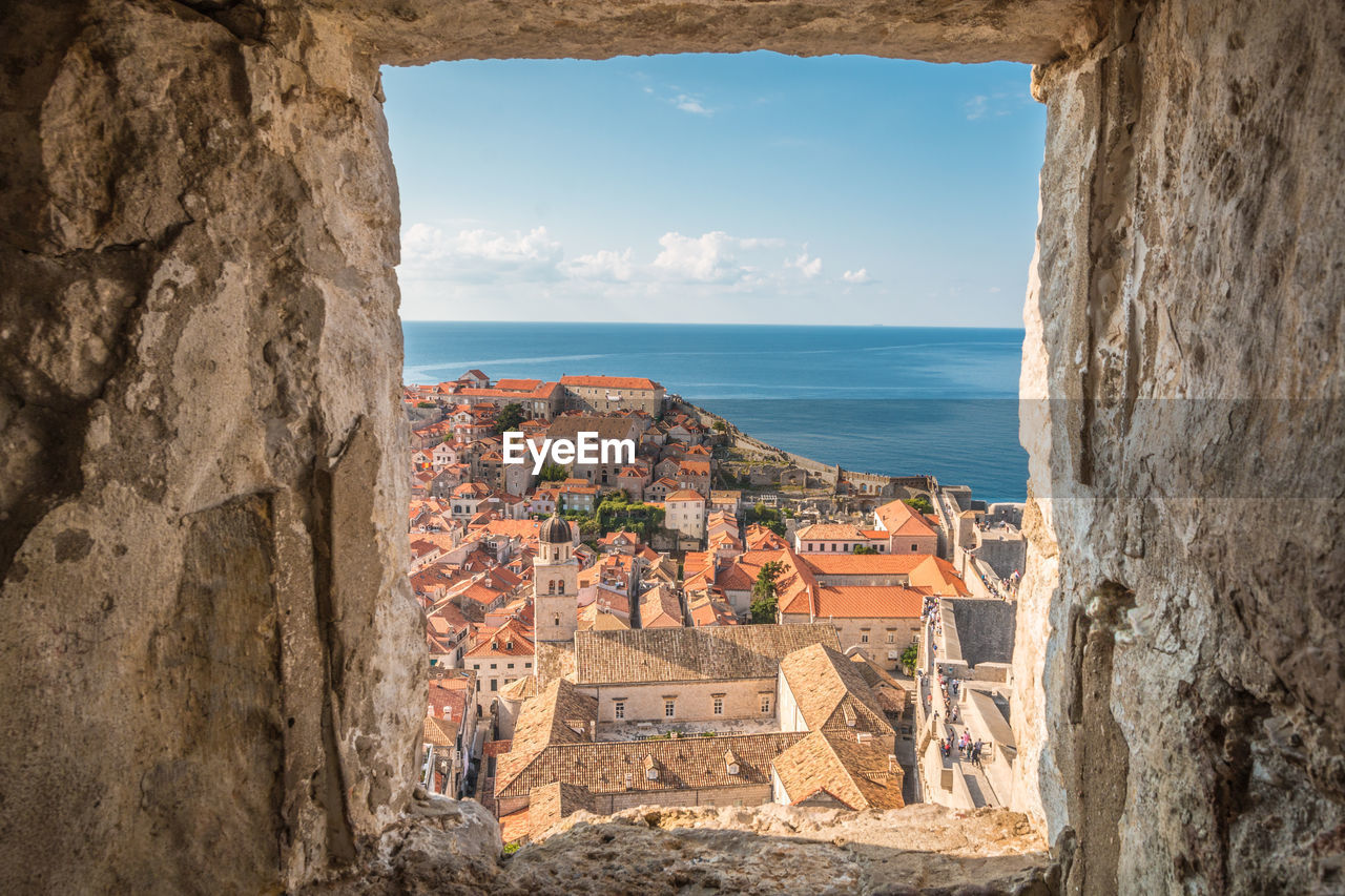 Panoramic view of sea and buildings against sky