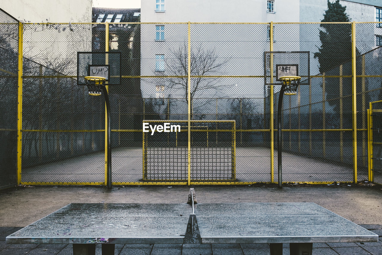 Table tennis by soccer field at park