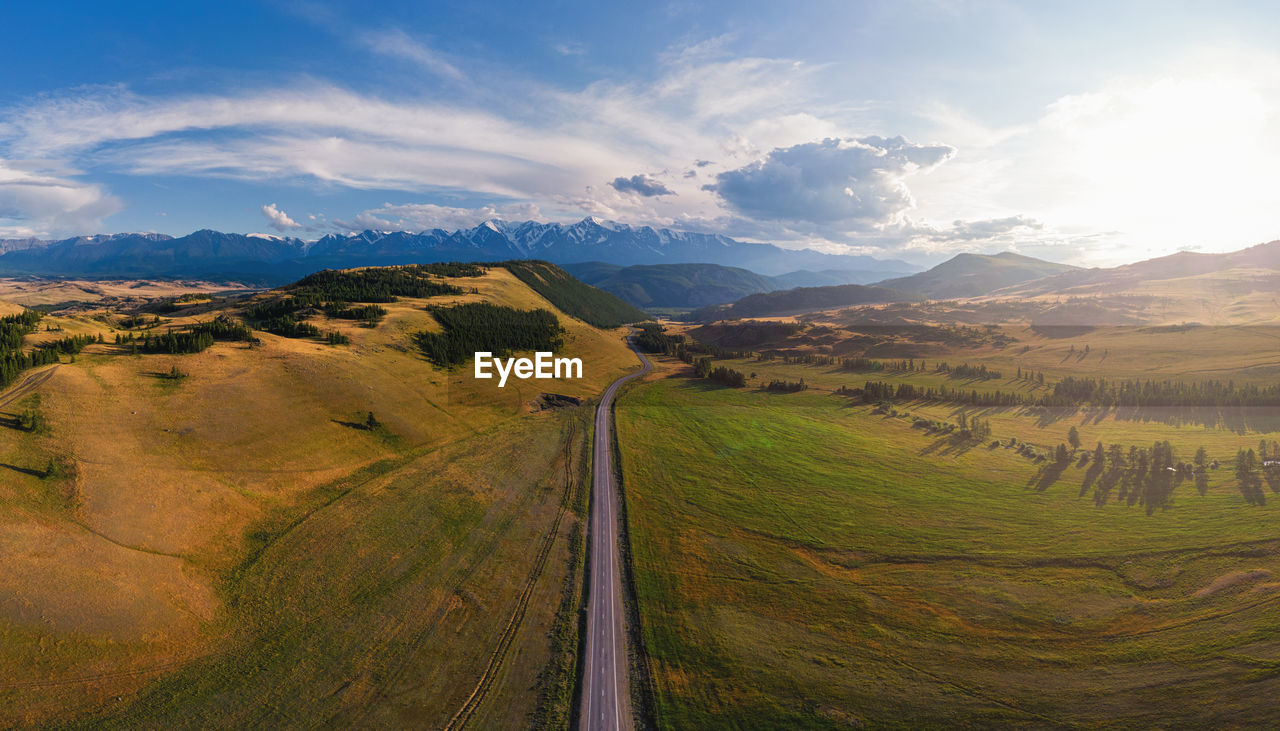 PANORAMIC VIEW OF ROAD LEADING TOWARDS MOUNTAINS