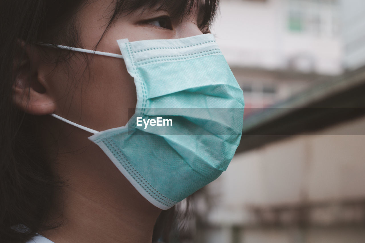 Close-up of teenage girl wearing face mask