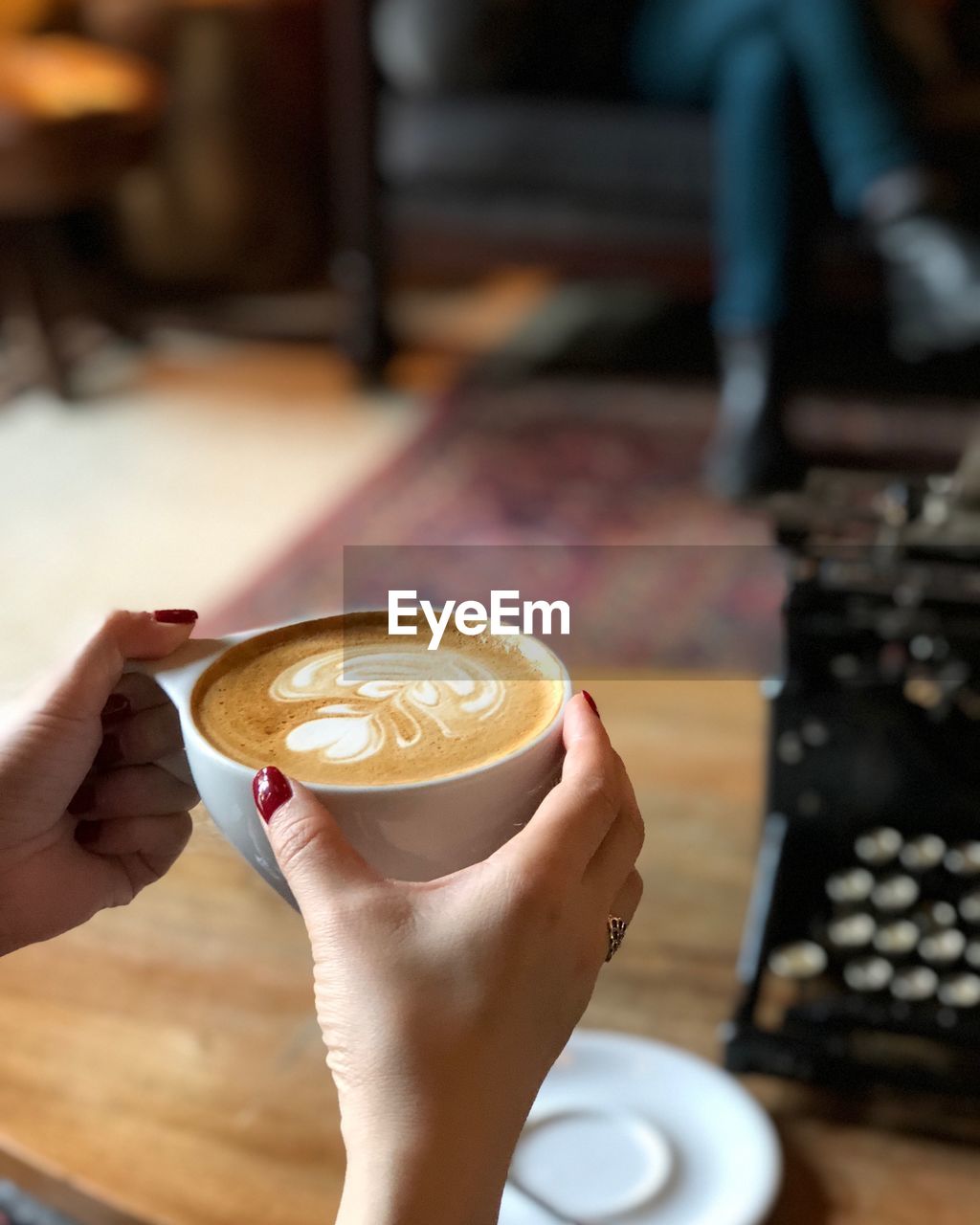 Woman holding a cup of latte coffee