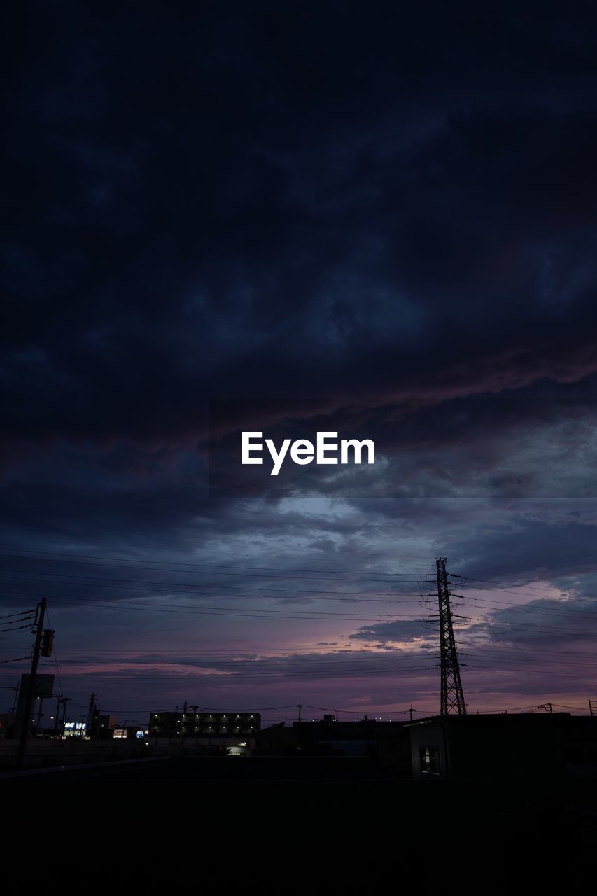 SILHOUETTE OF POWER LINES AGAINST CLOUDY SKY