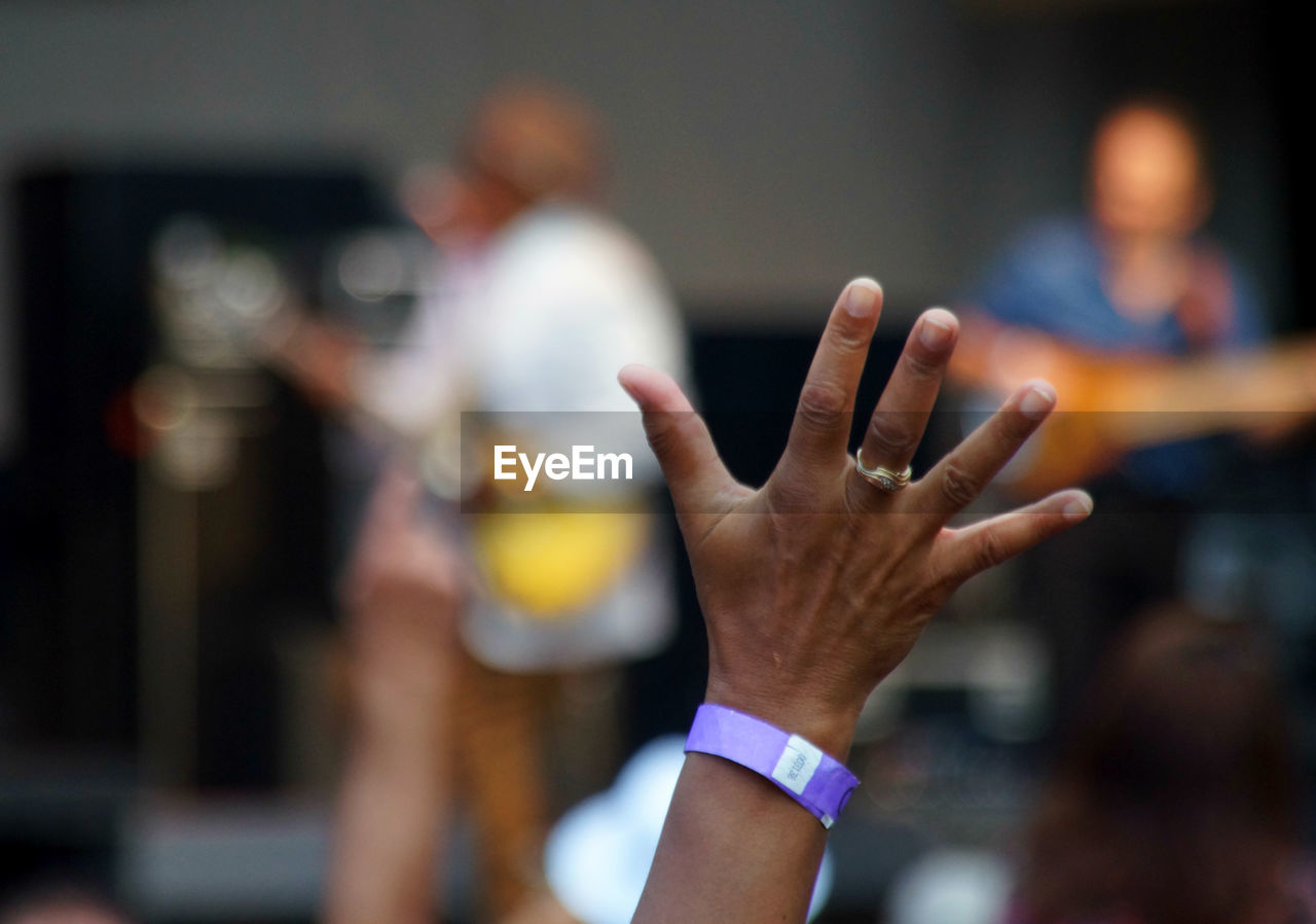 Cropped image of hand at music concert