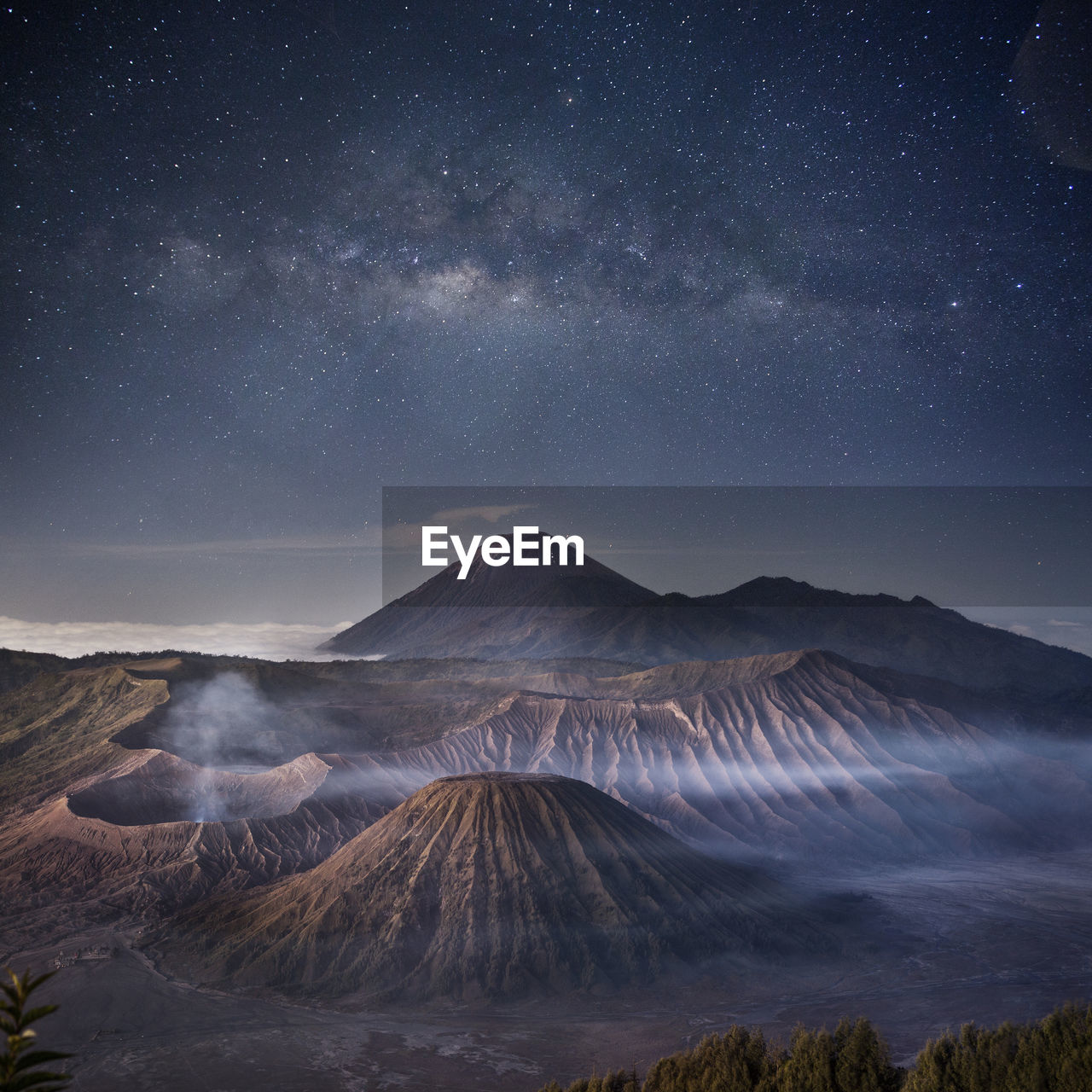 Scenic view of mountains against sky at night