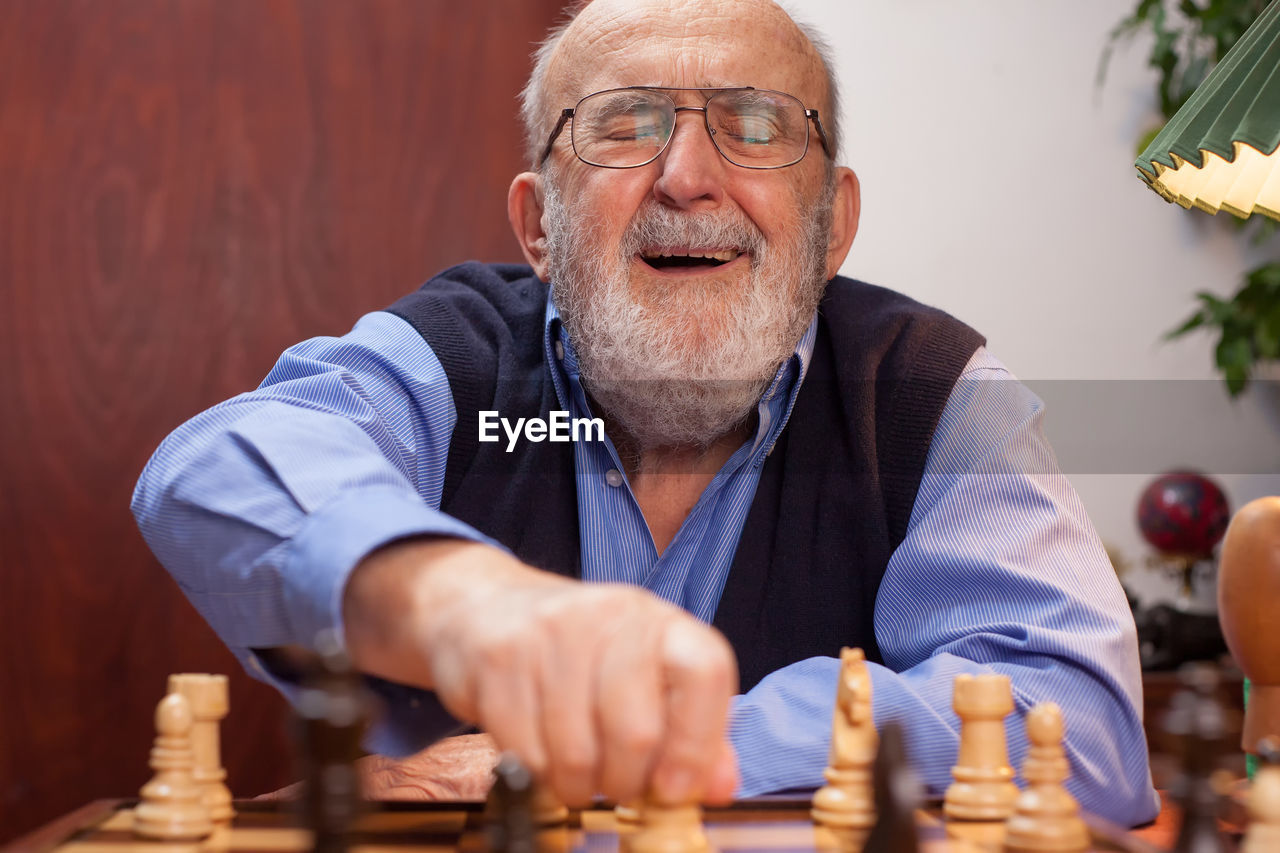 LOW ANGLE VIEW OF MAN PLAYING WITH TABLE