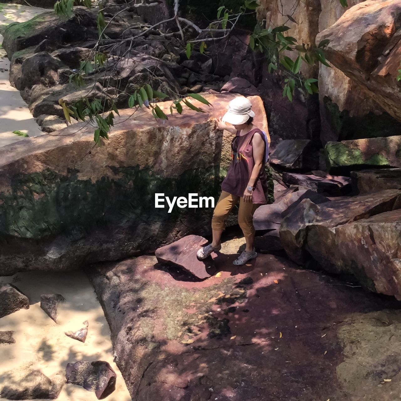 Full length of woman walking on rocks