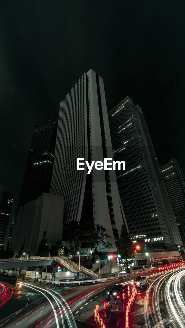 AERIAL VIEW OF ILLUMINATED BUILDINGS IN CITY AGAINST SKY