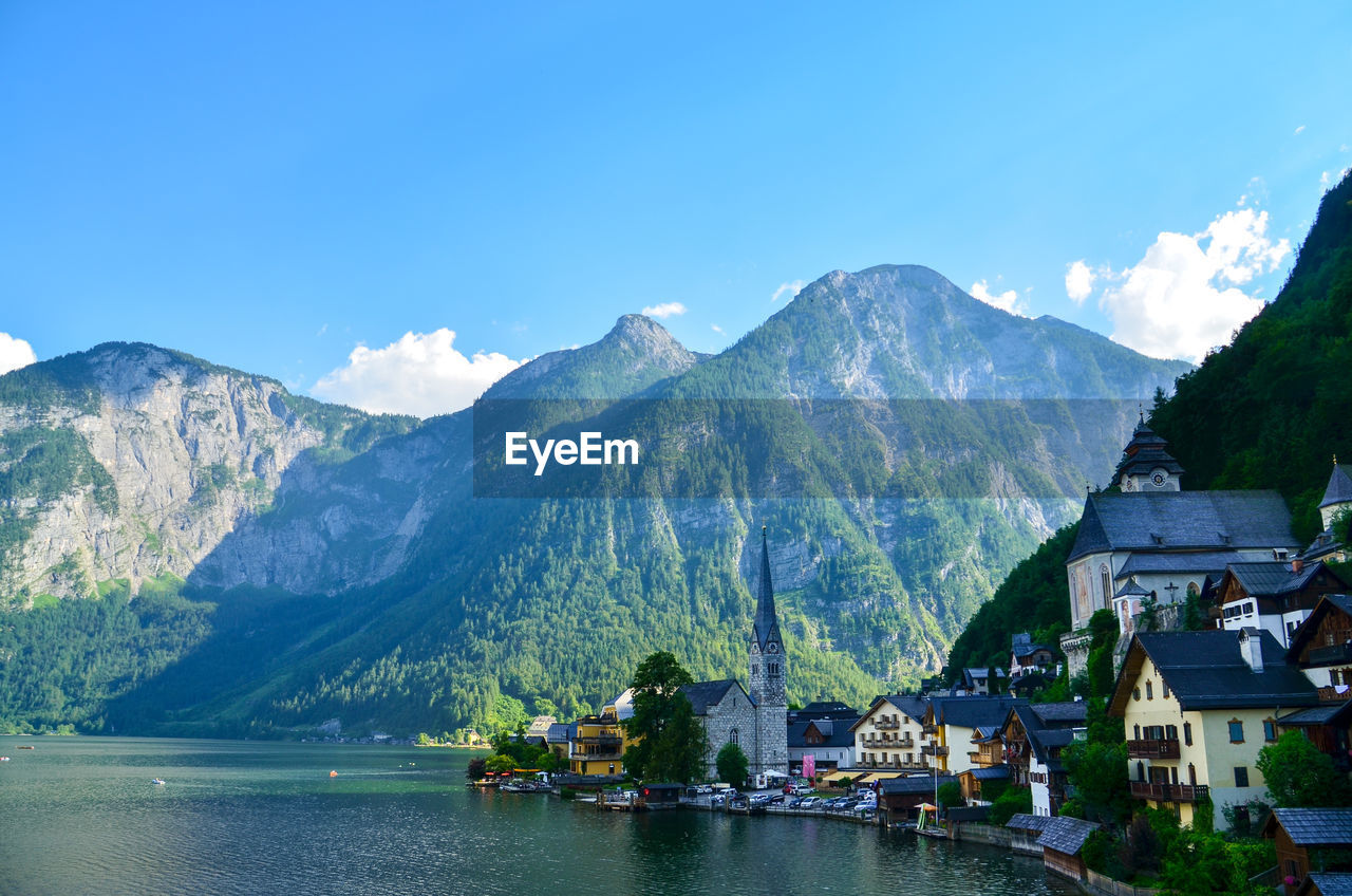 Scenic view of lake and buildings against sky