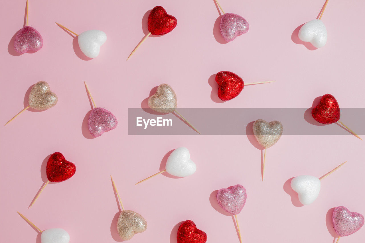 Creative glitter heart lollipop pattern. concept for valentine's day. flat lay. copy space