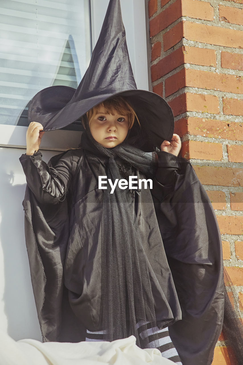 Adorable child on porch dressed in halloween costume