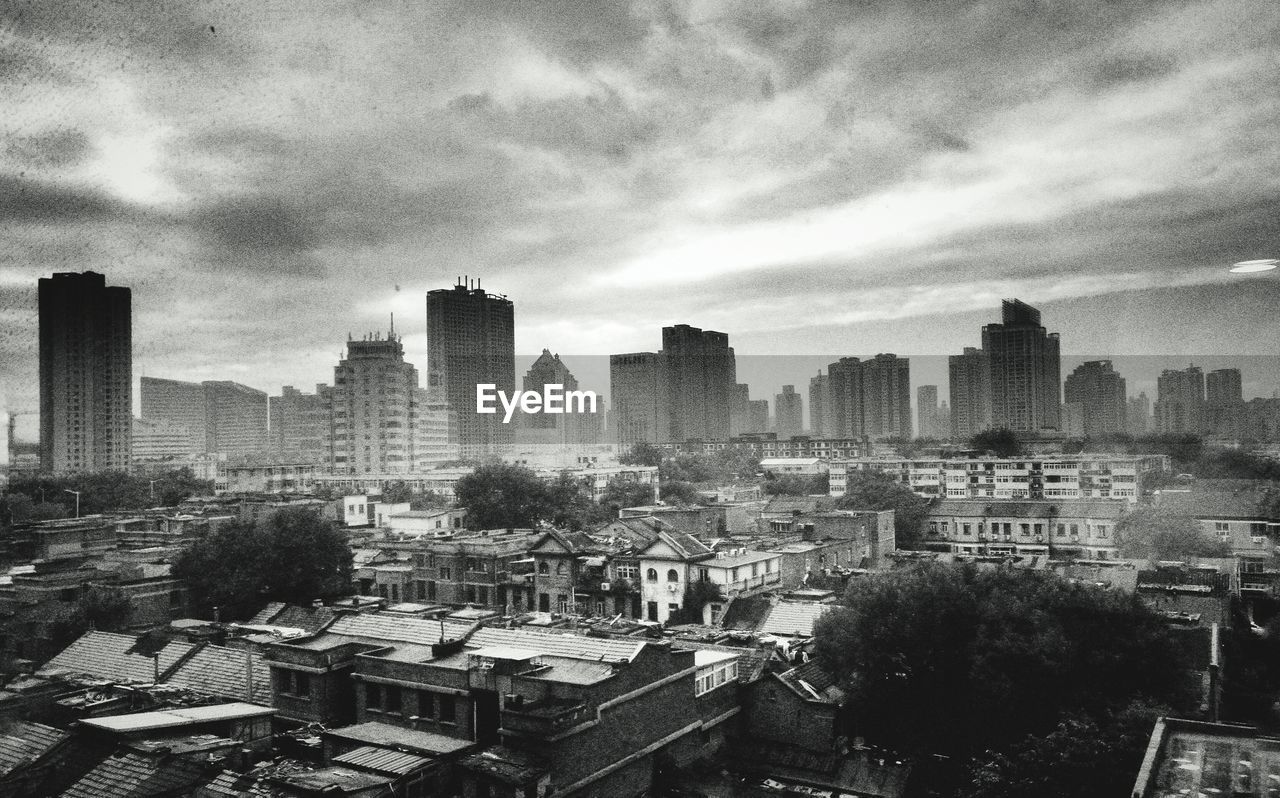 City skyline against cloudy sky