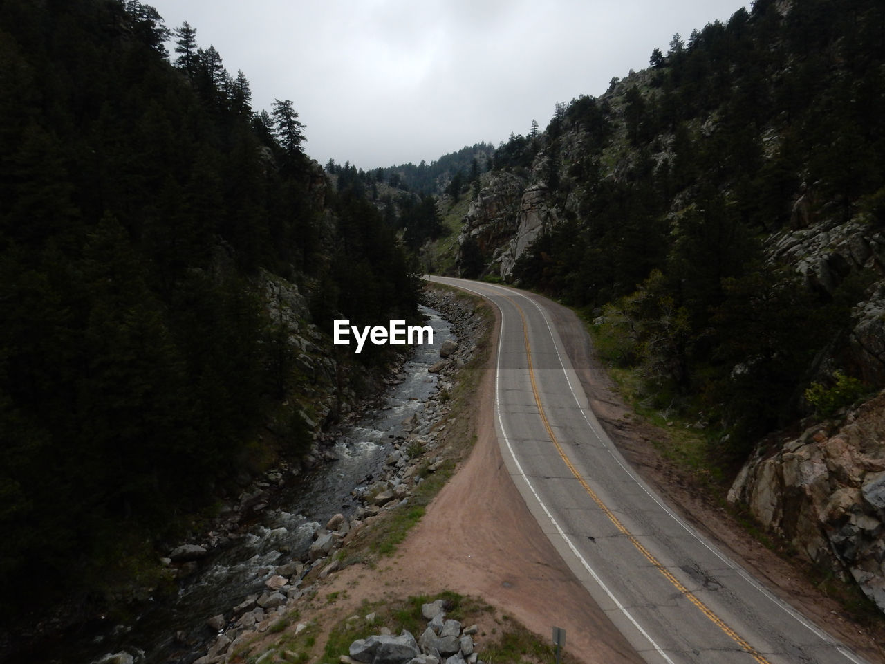 Road amidst mountains against sky