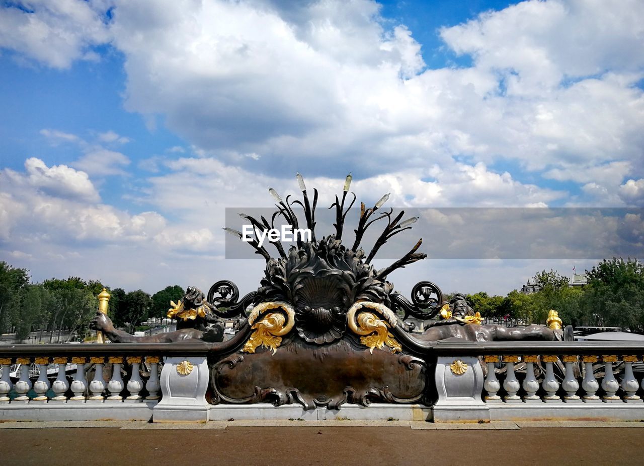 STATUE OF METAL AGAINST SKY