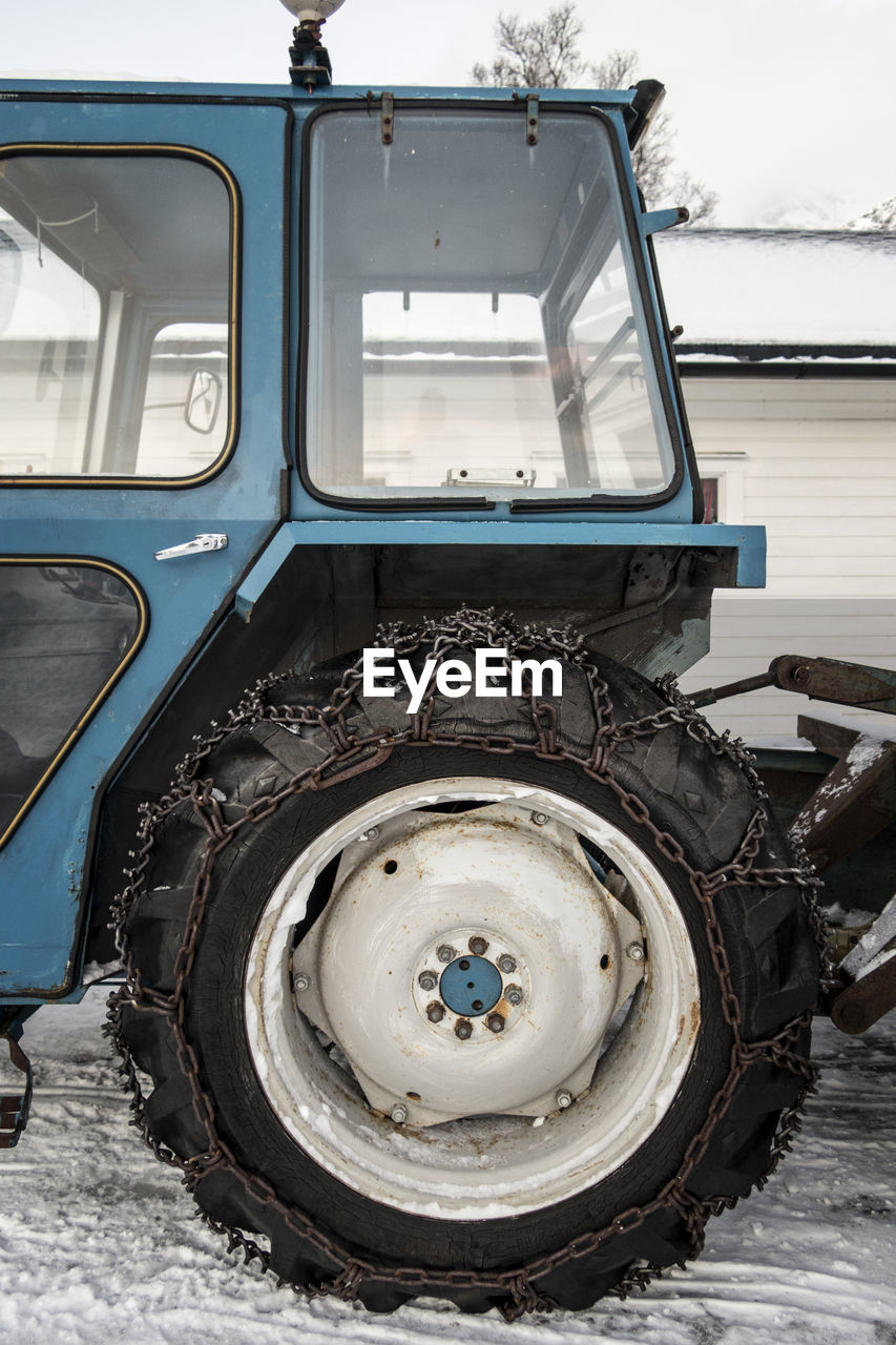 Cropped image of construction vehicle on snow covered field