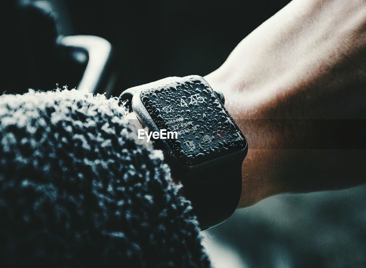 Close-up of water drops on wristwatch