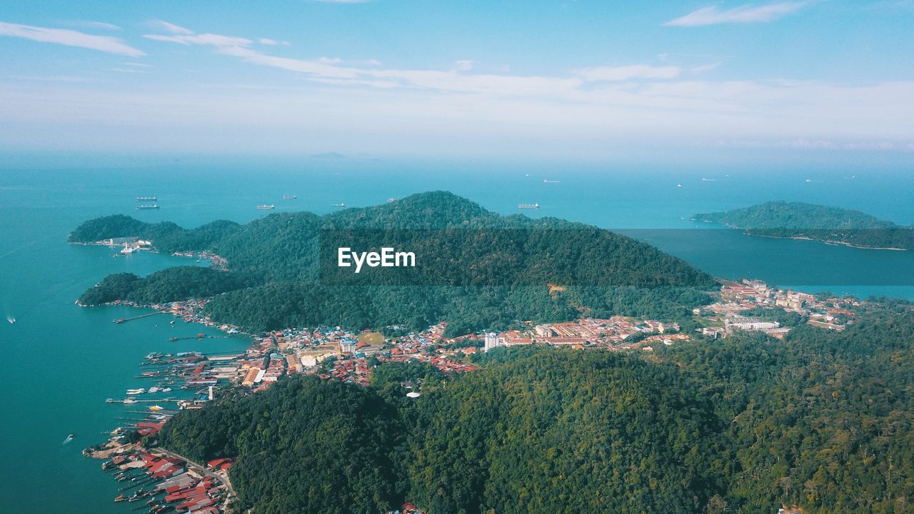 High angle view of cityscape by sea against sky