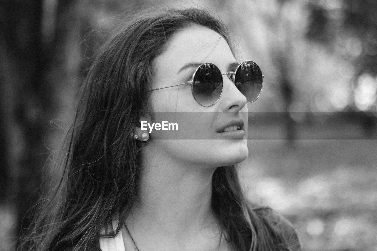 Close-up of beautiful young woman wearing sunglasses