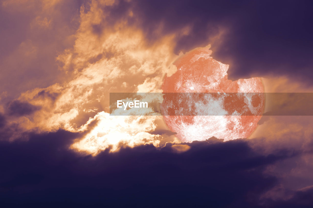 LOW ANGLE VIEW OF SUN STREAMING THROUGH CLOUDS