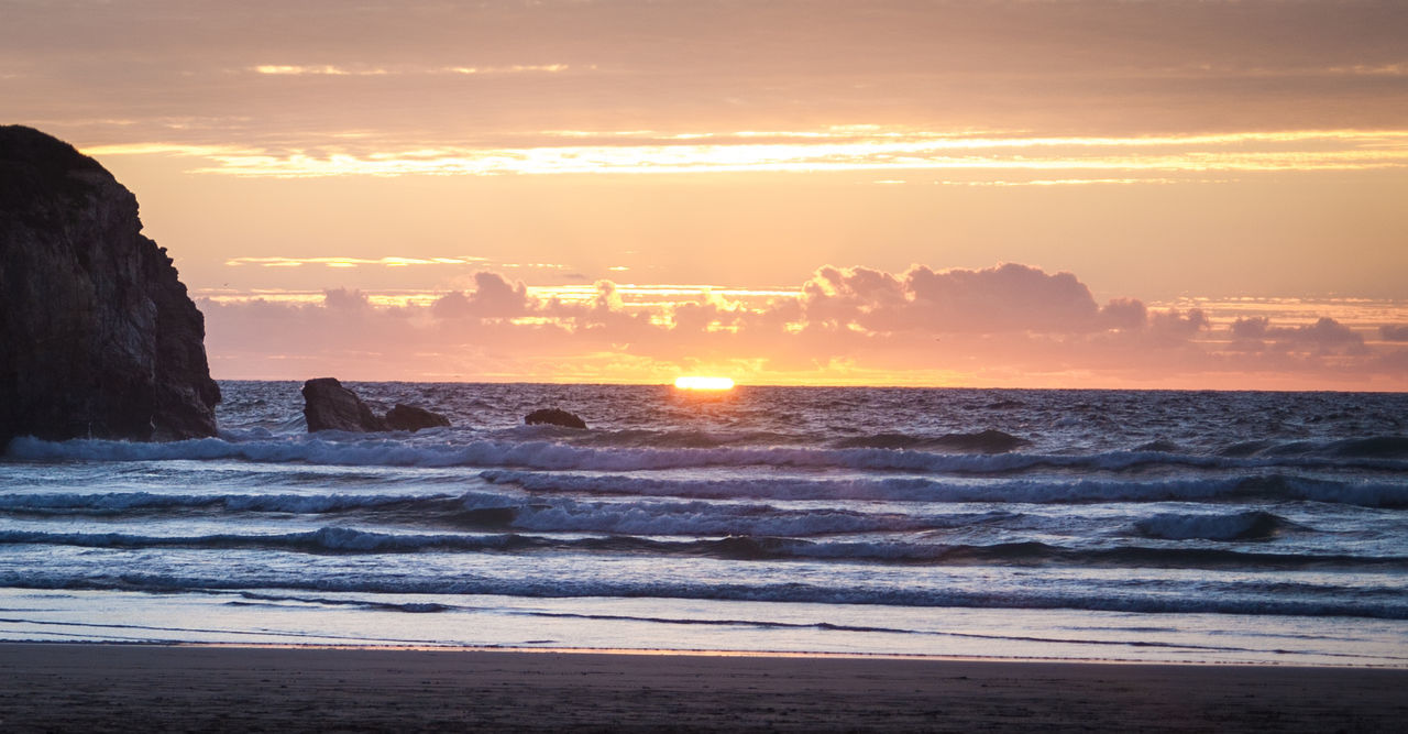 View of calm beach at sunset