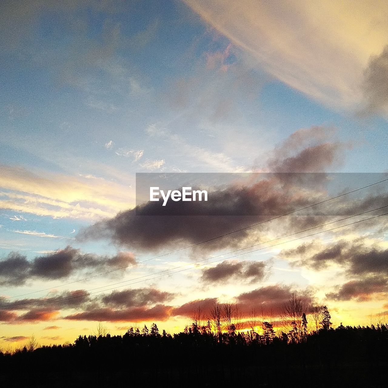 LOW ANGLE VIEW OF SILHOUETTE LANDSCAPE AGAINST DRAMATIC SKY